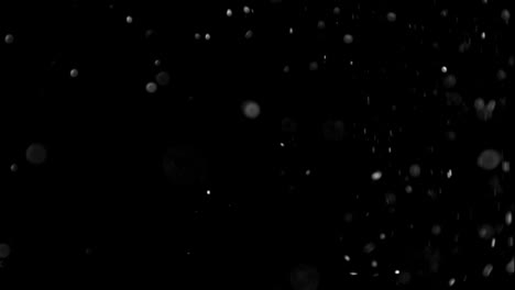 Dust-Particles-effect-flying-seamless-loop-in-slow-motion-on-black-background